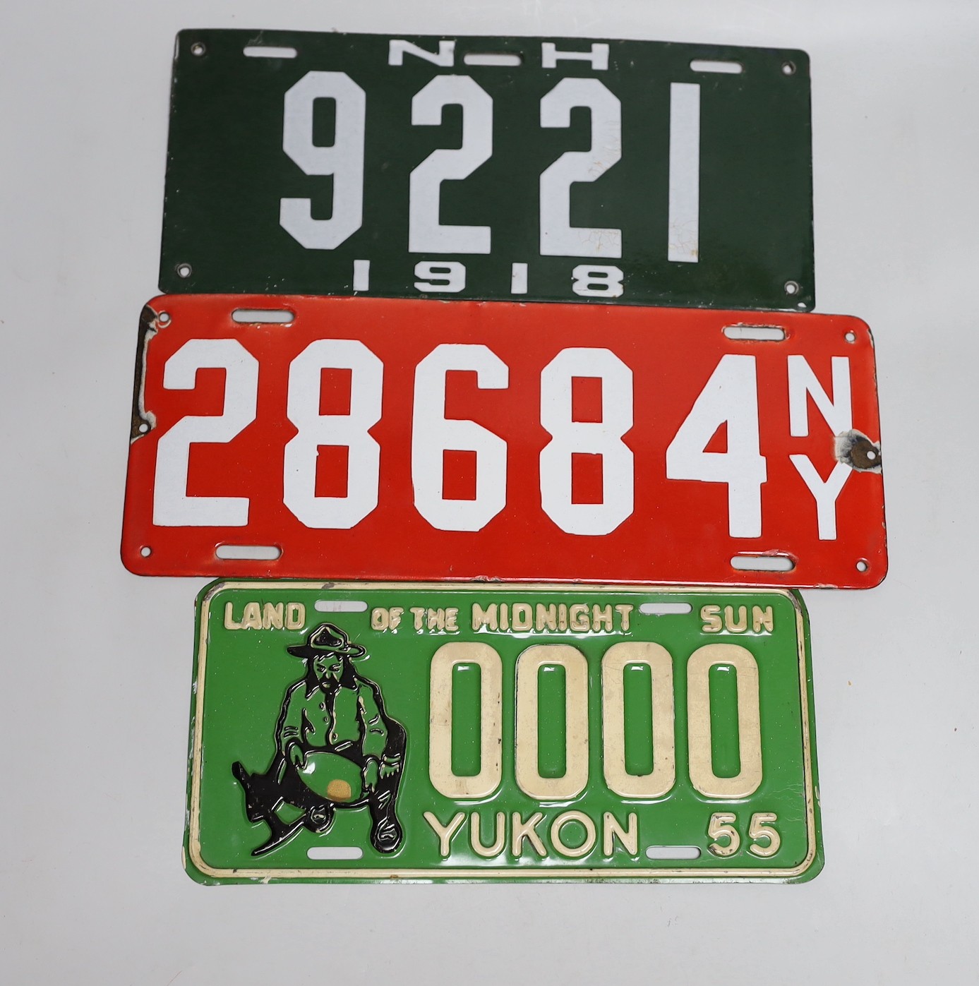 A mixed group of nine USA enamel car registration number plates